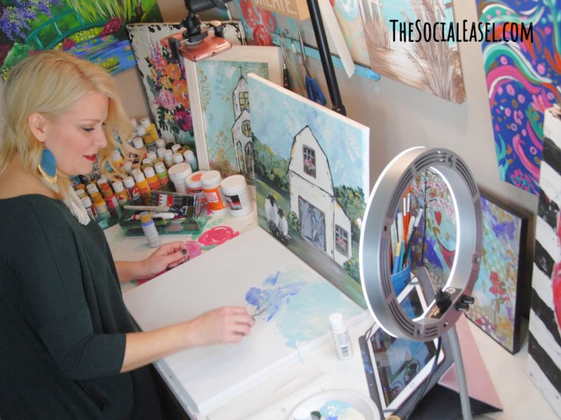 Christie Hawkins Palette Knife Painting a background in her art studio with supplies all around_Art is Therapy