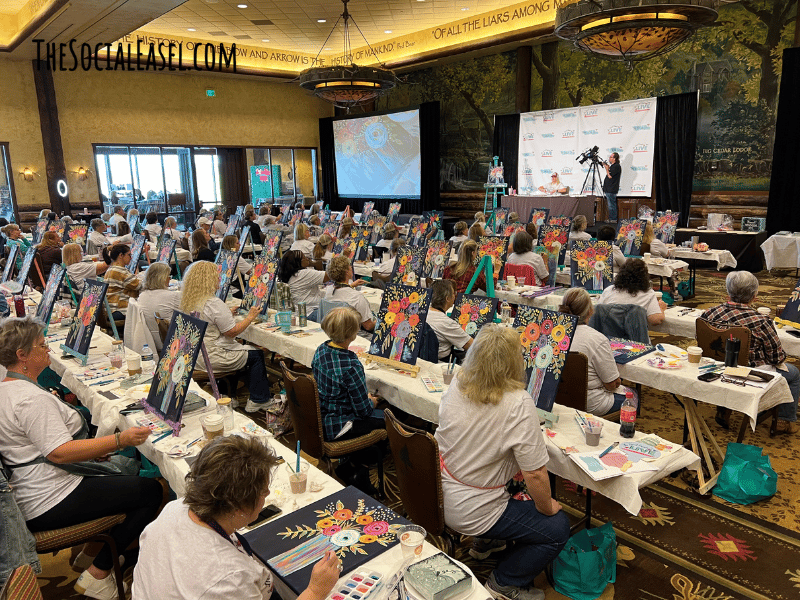 Room full of women painting with instructor Christie Hawkins