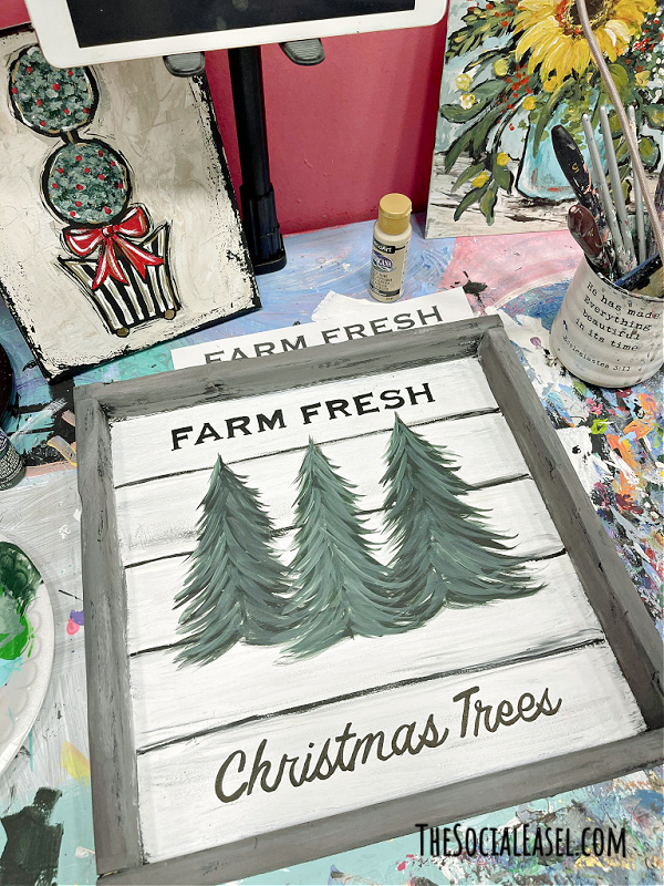 finished painting my DIY Christmas Tree Farm Sign on my desk