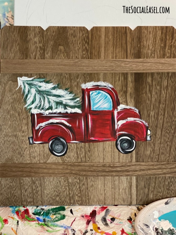 Vintage red truck painted on wood pallet