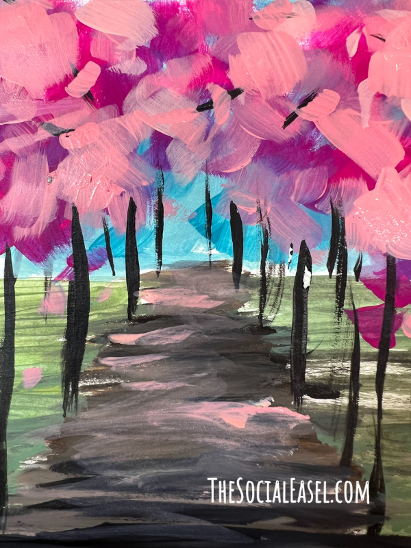 A spring path with abstract light and dark pink trees with dark trunks. Line up along a dirt path. 