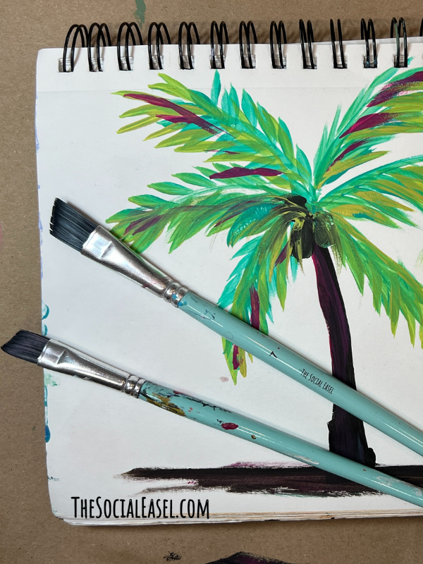 A palm tree with 2 angled paintbrushes. One large, and one small.
