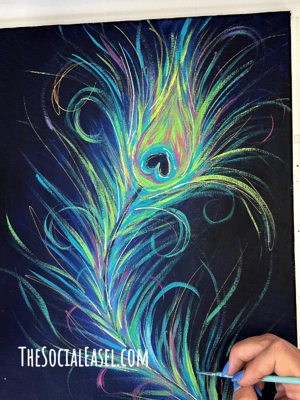 Acrylic painted peacock feather. Adding paint strokes to create part of the feather. 