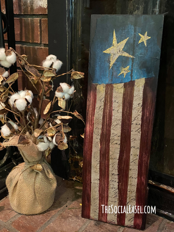 Rustic Americana Flag painted in Red, White, and Blue. 3 off white stars at the top with a blue background. The bottom is red and white stripes. 
