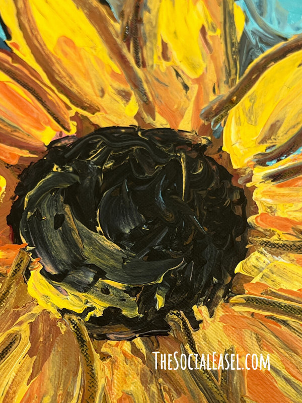 The center of a sunflower painted with palette knives. 