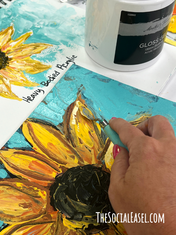 Spreading the paint with a pallet knife on the sunflower petal.